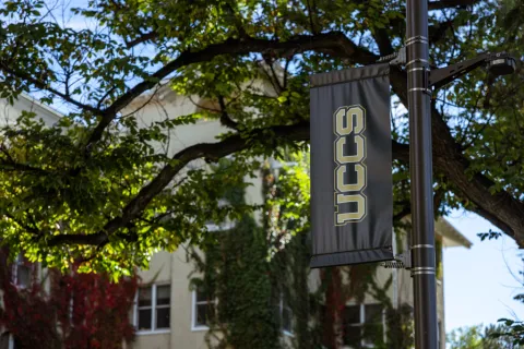UCCS banner in front of Main Hall building